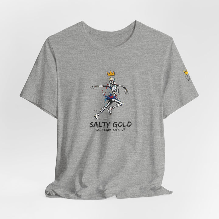 SALTY GOLD Skeleton Figure Skating Tee. Heather grey t-shirt with gold crown, blue, red graphic.