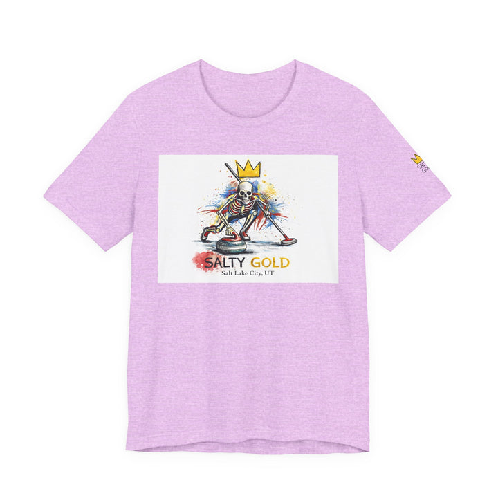 Light purple Salty Gold skeleton curling sweep tee. Colorful watercolor graphic with a skeleton wearing a gold crown.
