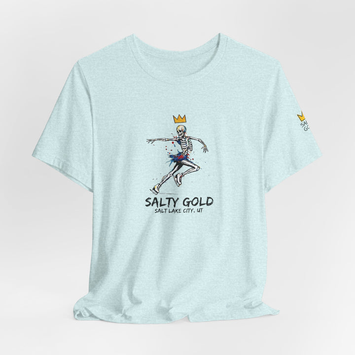Light blue Salty Gold skeleton figure skating tee with gold crown and colorful splatters.