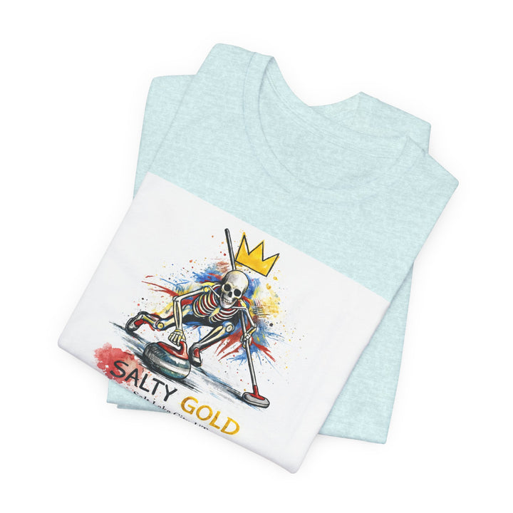 Salty Gold Skeleton Curling Tee. Light blue shirt with white graphic of crowned skeleton sweeping a curling stone.