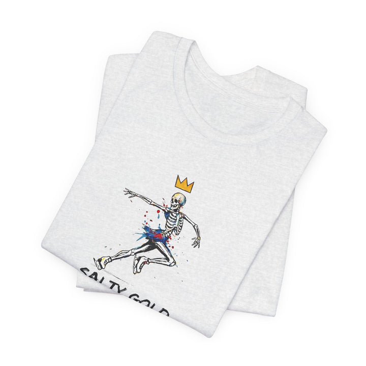 Light grey Salty Gold t-shirt featuring a colorful skeleton figure skating with a gold crown.